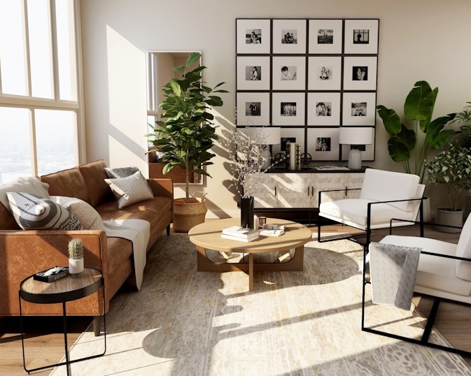 Bright living room with tan leather sofa, white armchairs, indoor plants, and a grid of framed photographs on the wall